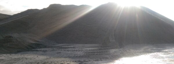 Sunlit piles of industrial aggregate 